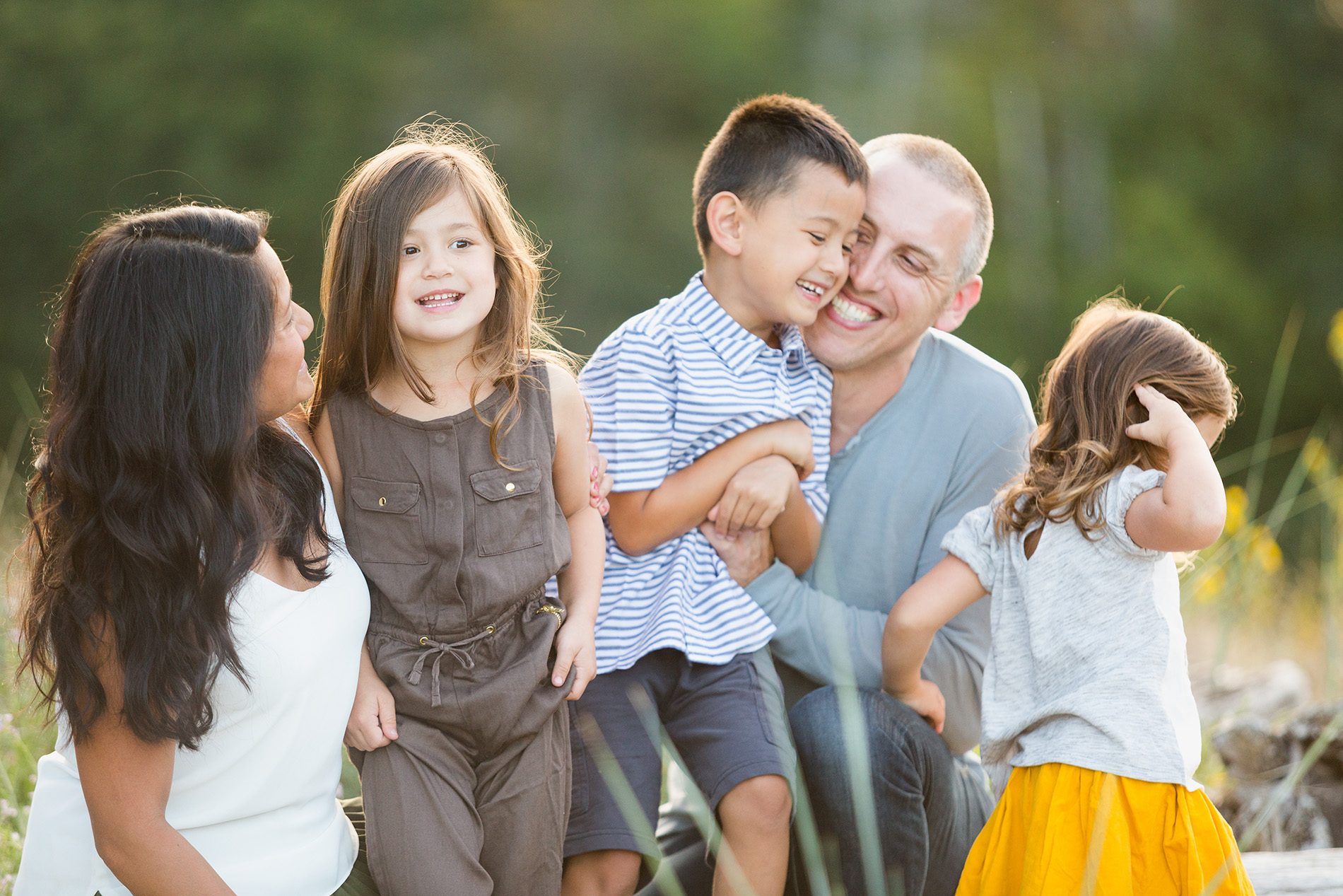 a family cuddles together and laughs during their fun family photoshoot with Christine Dammann