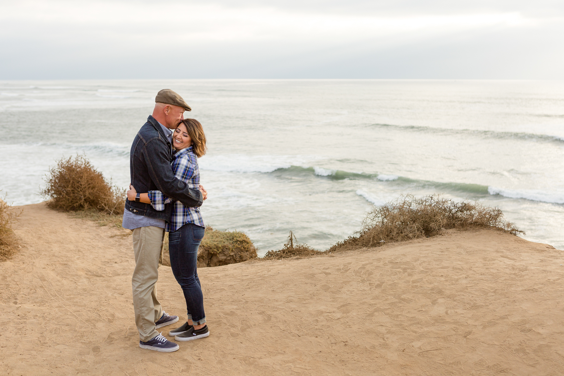 couple hugging at sunset cliffs San Diego