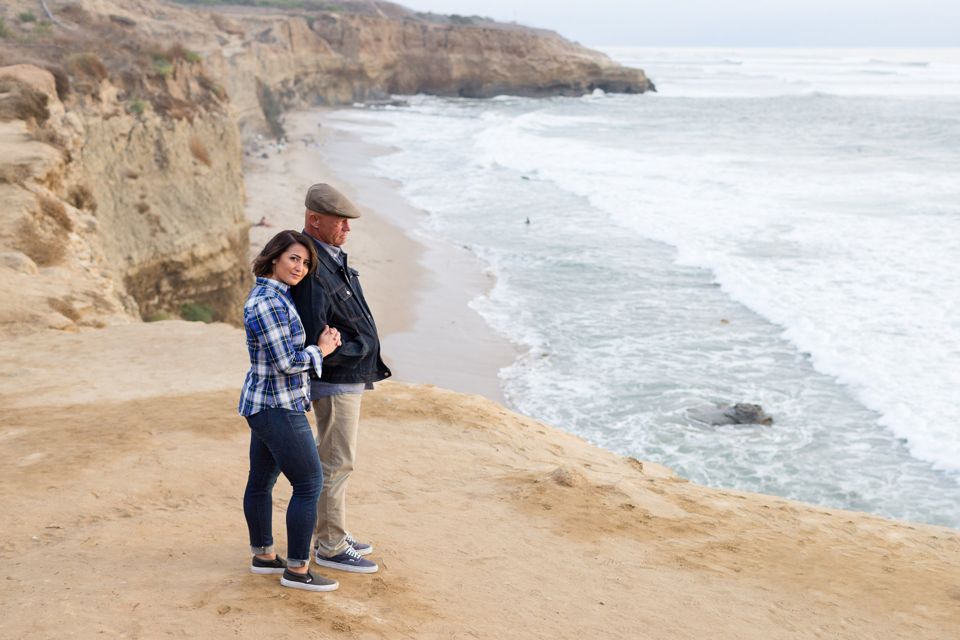 couple hugging at sunset cliffs San Diego