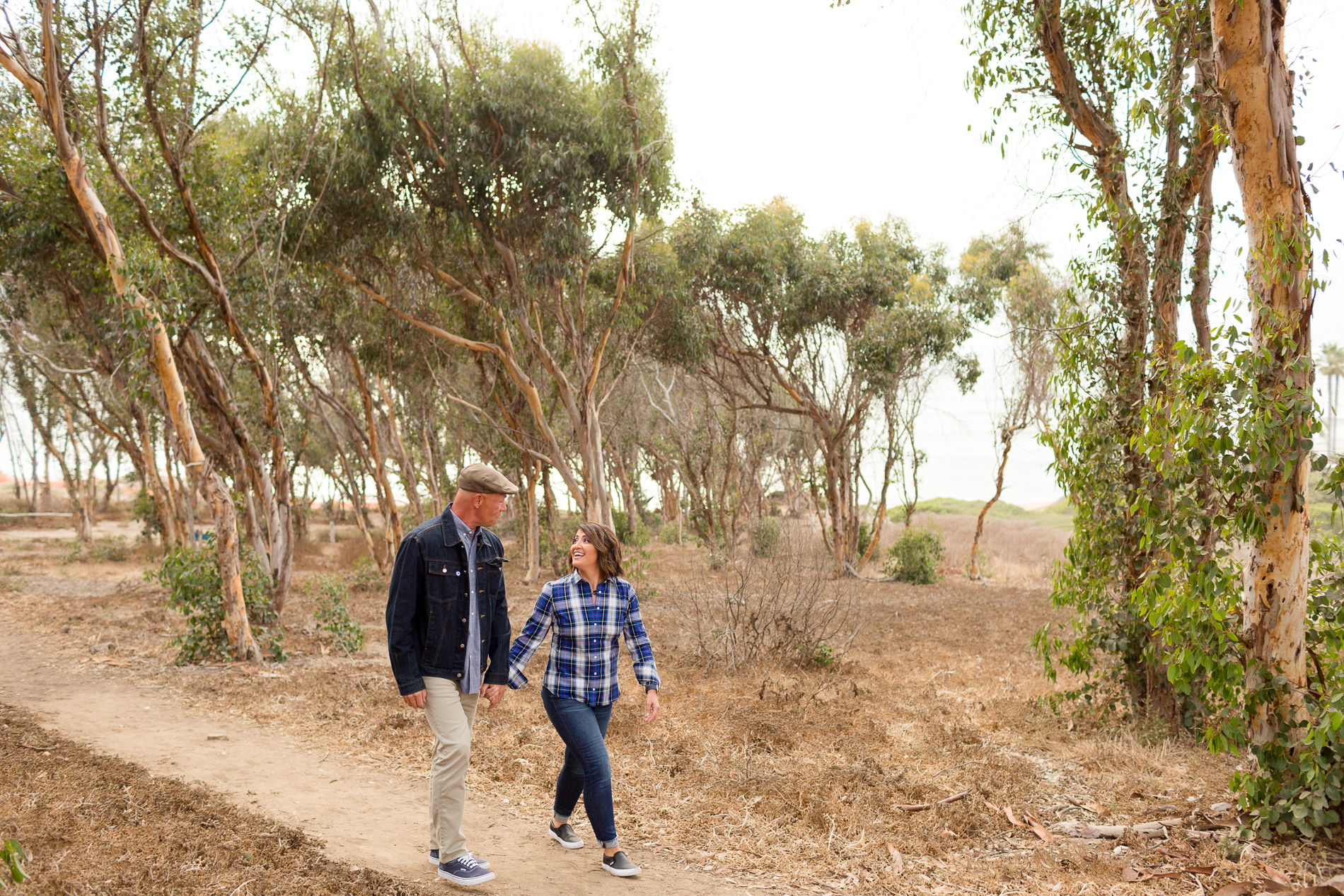 couple walking through eucalyptus grove