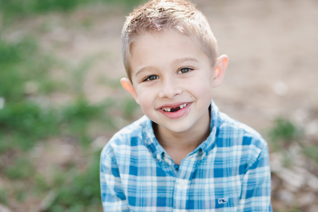boy smiles on his first day of school