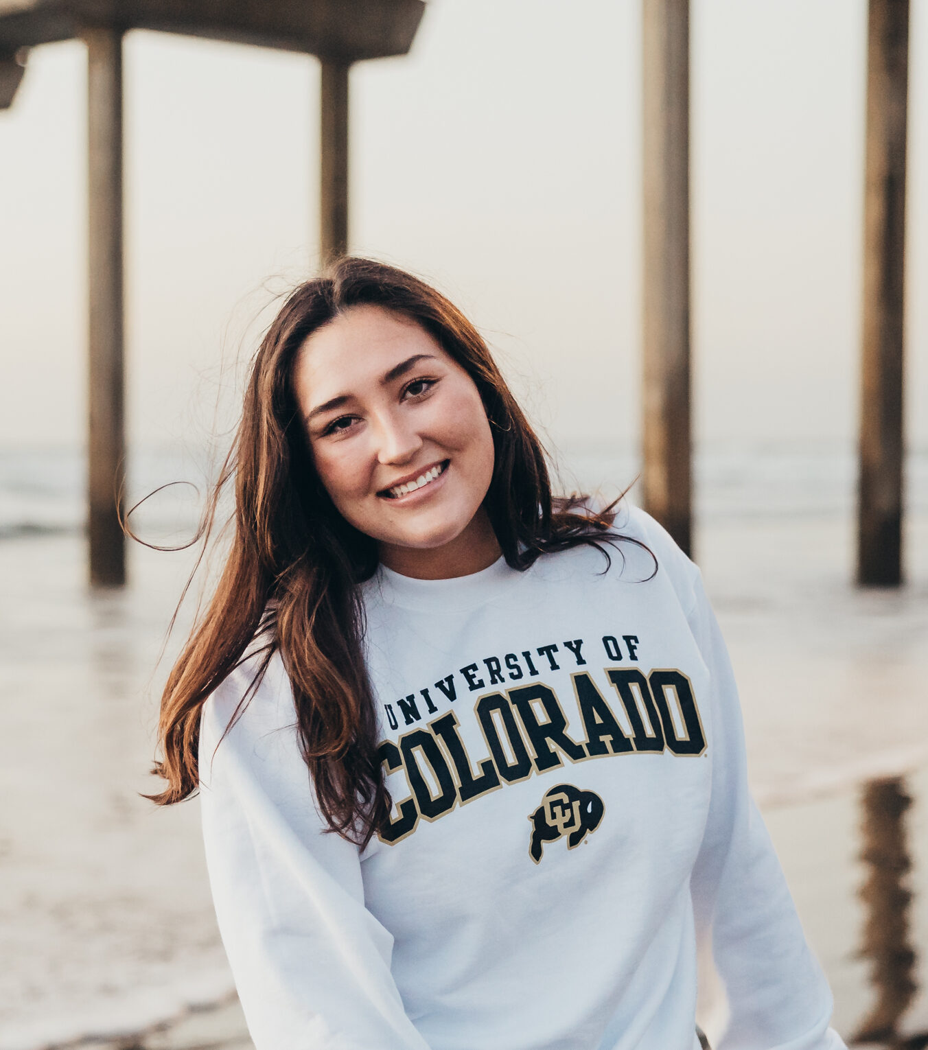 Girl taking senior photos in San Diego on the beach