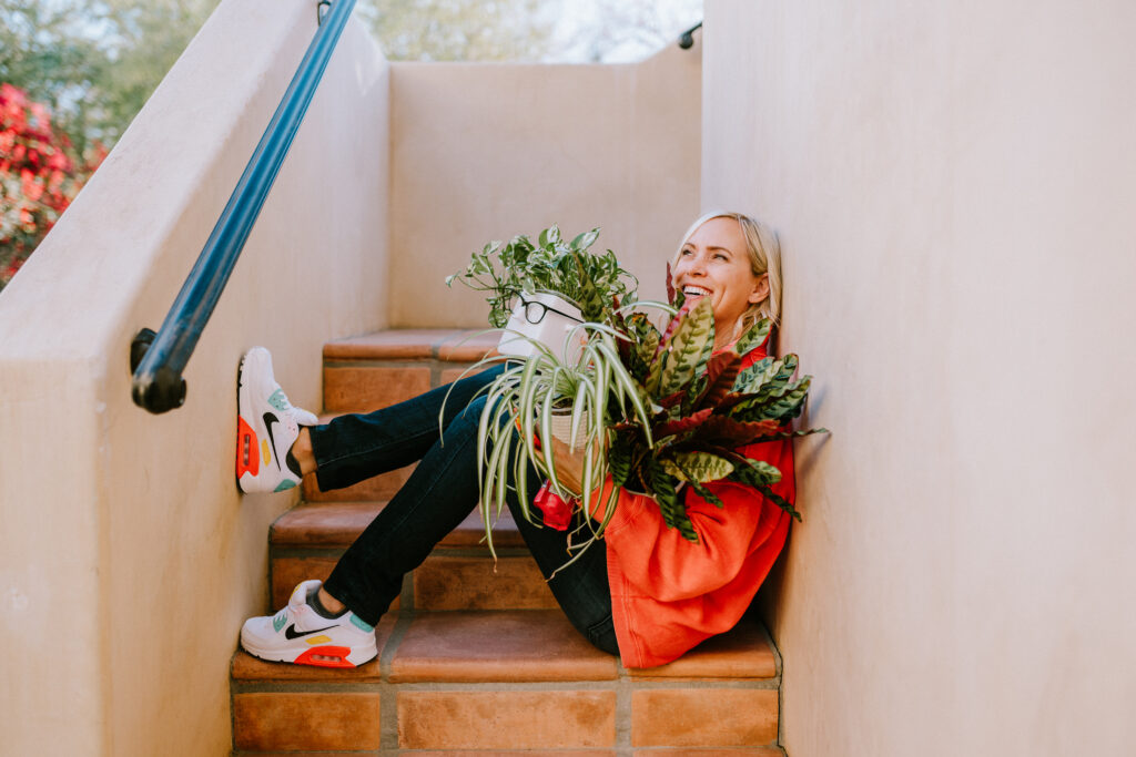 woman holding plants on stairwell | photography education