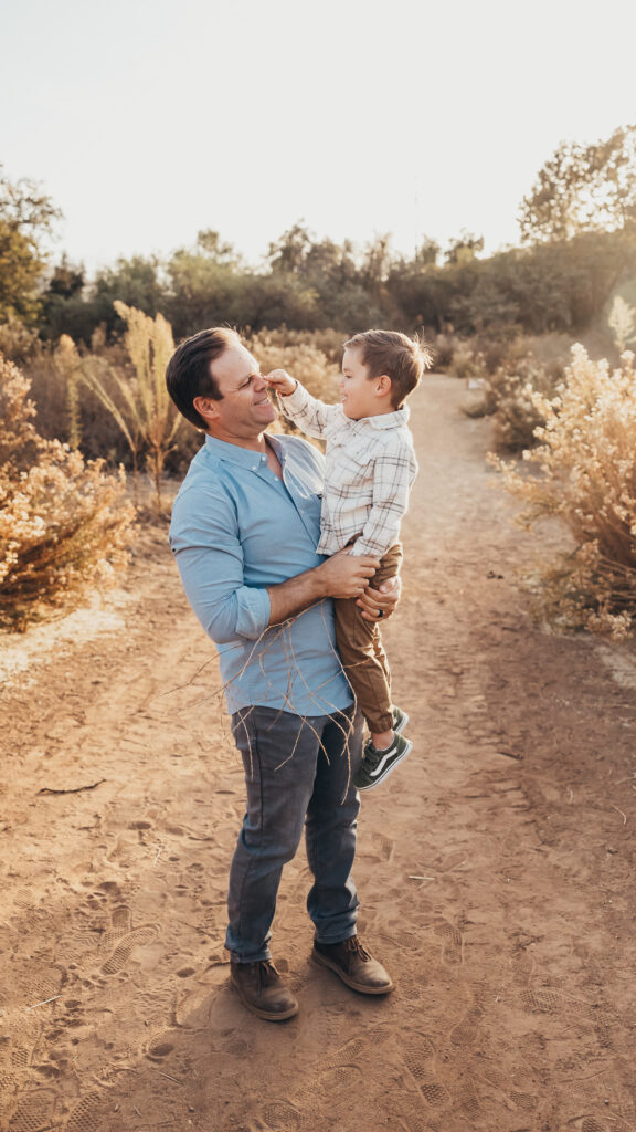 Dad and son taking fun family photos together