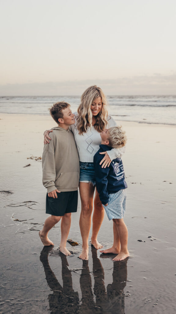 Mom and son taking fun photos on the beach