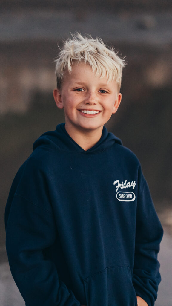 Little boy taking school photos outside